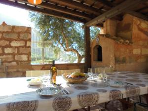 una mesa con un bol de fruta y una botella de vino en Baglio Poma, en Castelluzzo