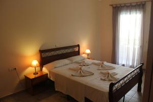Кровать или кровати в номере El Greco Apartments