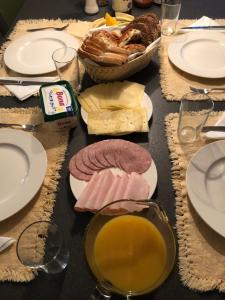 a table topped with cheese and meats and bread at Floriande Stay in Hoofddorp +21 photos