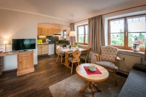 a living room with a kitchen and a dining room at Allgäu-Moni in Füssen