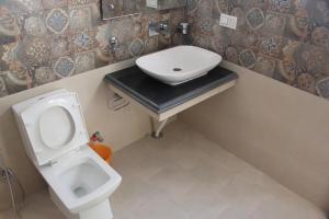 a bathroom with a toilet and a sink at New Moon Guest House in Leh
