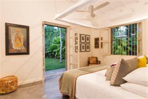 a bedroom with a bed and a large window at Monara House, Talpe in Unawatuna +34 photos