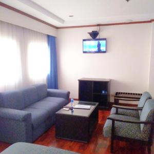 a living room with a couch and a table at CityState Tower Hotel in Manila