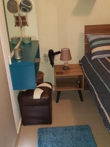 a bedroom with a bed and a table and a chair at Ria Court 33 in Larnaka