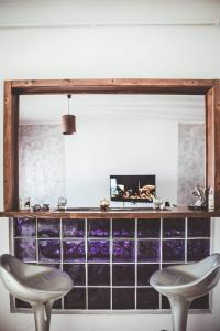 a room with two chairs and a counter with purple tiles at Home sweet home in El Aouina