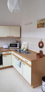 a kitchen with a sink and a stove top oven at FeWo im Herzen Reichenbachs in Reichenbach im Vogtland
