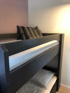 a bunk bed with a black bed frame and pillows on it at Gastenverblijf De Lorem in Leusden