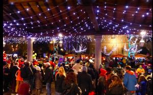 a crowd of people walking around a christmas market at ECRINS ETOILE C9 in Samoëns