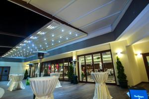 a restaurant with white chairs and lights on the ceiling at Hotel Hegsagone Marine Asia in Gebze +32 photos