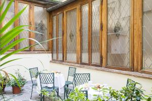 a patio with a table and chairs and a window at Hotel Accademia in Florence