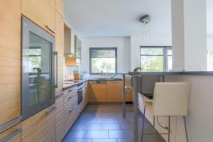a kitchen with a table and a chair in it at IVY'S CORNER in Luxembourg