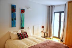 a bedroom with a bed and a window with a view at Quinta Vale da Prata in Celorico da Beira +73 photos