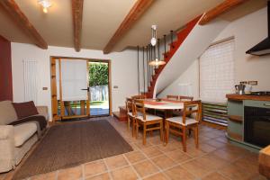 a kitchen and living room with a table and chairs at Kronau Chalet Resort in Kranjska Gora