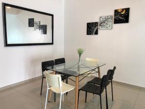 a dining room with a glass table and chairs at Family homestay in Kuala Selangor