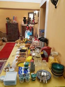 a table with plates and dishes on it at Riad Dar Rita in Ouarzazate