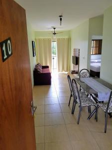 - un salon avec une table, des chaises et un canapé dans l'établissement Bonito Residencial Flat, à Bonito