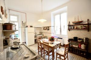 cocina y comedor con mesa y sillas en " La Casa di Lella ", en Génova
