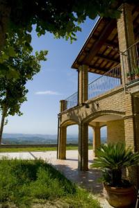 a building with a balcony on the side of it at Agriturismo Aqua Viva in Acquaviva Picena