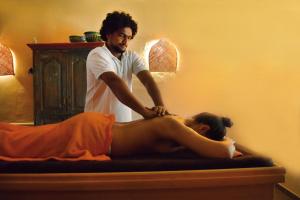 a man giving a woman a massage on a bed at Villa Veda in Zehdenick