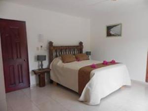 Postel nebo postele na pokoji v ubytování Hotel Rancho Don Cesar
