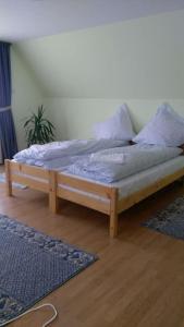 a wooden bed with pillows on it in a room at Casa Bis in Sibiu