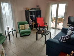 a living room with colorful chairs and a tv at Greg's apartment in Argostoli