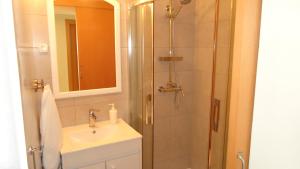 a bathroom with a shower and a sink at Vilas do Mar in Carvoeiro +24 photos