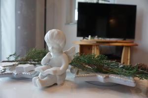 a small white angel figurine sitting on a table at Ferienwohnung Bergblick in Sulzberg