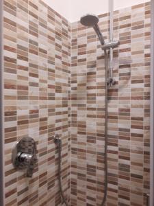 a shower in a bathroom with a tile wall at casa maria in Sestri Levante