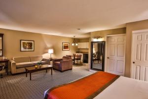 a hotel room with a bed and a living room at Tuscany Suites & Casino in Las Vegas