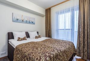 Katil atau katil-katil dalam bilik di Karlson Lux Apartments