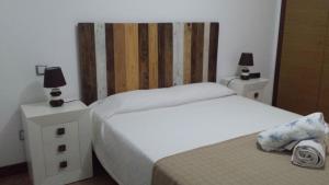 a bedroom with two beds and two night stands with lamps at Playa de Consolaçao in Consolacao