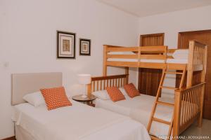 1 dormitorio con 2 literas y escalera en Pousada Villa D'Ouro, en Penha