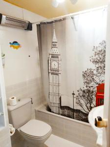 a bathroom with a shower curtain with a clock tower at Apartamentos Esmeralda 2 in Calpe