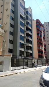 a parking lot in front of some tall buildings at Apto 3 quartos 103m² in Itapema