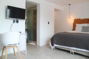 Cama ou camas em um quarto em Hotel Florinda