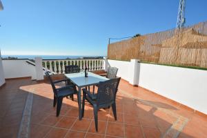 a patio with a table and chairs on a balcony at Pura Vida El Morche in Torrox Costa