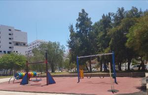 a playground with colorful play equipment in a park at Barbacoa Villaedu in Puebla de Farnals