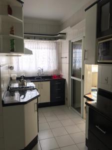 cocina con fregadero y encimera en 3 dorms com vista a 250 mts do mar no centro da Meia Praia Itapema, en Itapema
