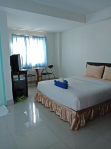 Säng eller sängar i ett rum på Baanpak Sam Anong
