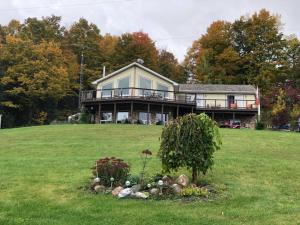 a large house on a hill with a yard at Our Valley View Bed & Breakfast in Hampton