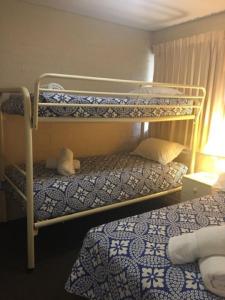 a bedroom with two bunk beds in a room at Riverview Holliday villa with River Views and Pool in Kalbarri