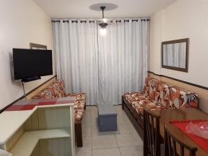 un soggiorno con divano e TV di Lexus Residence 210 a Florianópolis