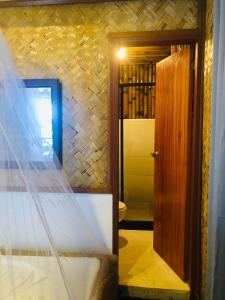 a bedroom with a bed and a wooden door at Ced Pension in El Nido