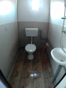 a small bathroom with a toilet and a sink at AsiaCamp - Cabin Sungai Sireh in Tanjung Karang