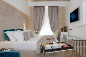 A bed or beds in a room at Navona Style