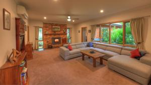 a living room with a couch and a table at Alpine Riverside Accommodation in Myrtleford