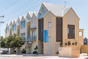 a large brick building with a large window at Serenity on the Terrace in Mandurah