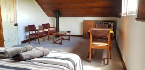 a room with a table and chairs and a kitchen at Barrington Church B&B in Barrington