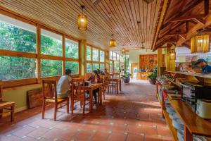 a room with people sitting at tables in a restaurant at Azura Resort in Phu Quoc
